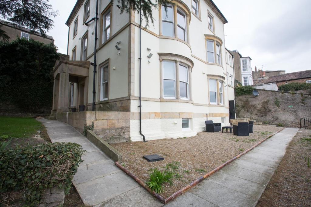 a large white building with a yard in front of it at 3 Frenchgate House in Richmond