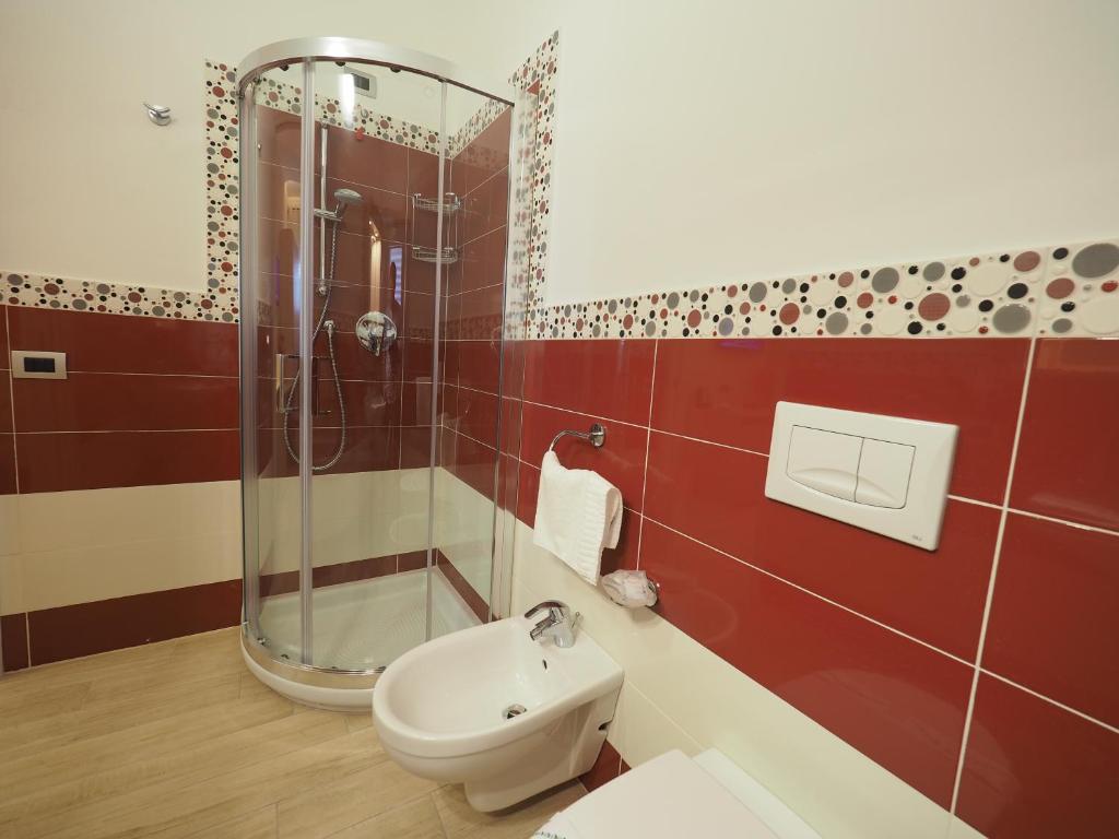 a bathroom with a shower and a toilet and a sink at B&B Galatea in Santa Domenica