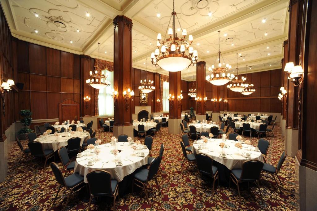 a banquet hall with tables and chandeliers at Kahler Grand Hotel in Rochester