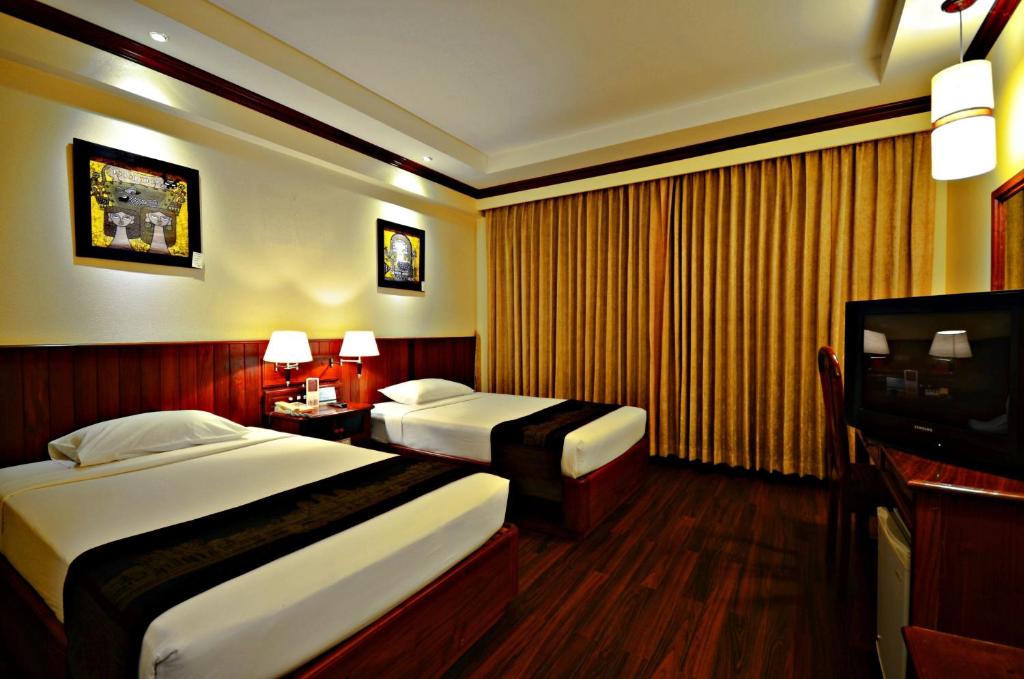 Postel nebo postele na pokoji v ubytování City River Hotel