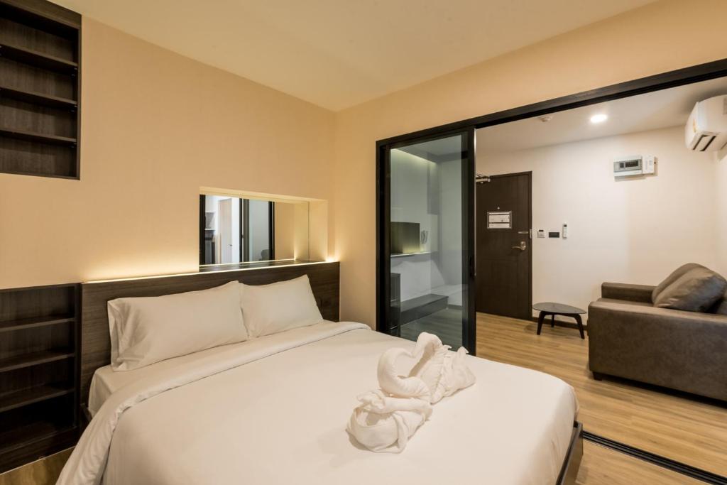 A bedroom with a double bed opening visually onto the adjoining living room.