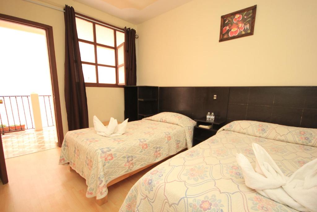 Postel nebo postele na pokoji v ubytování Hotel San Martin