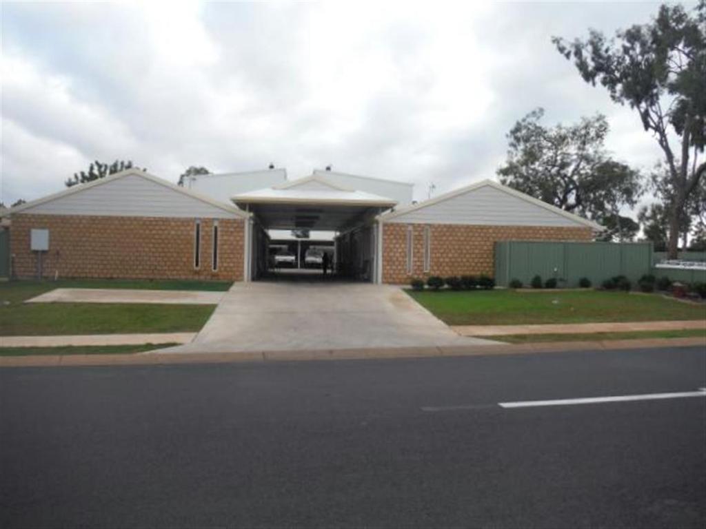 a large brick building with a large window at Units 37 on St Francis Drive in Moranbah