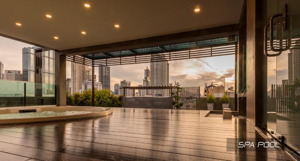 A rooftop spa pool terrace overlooking Bangkok’s skyline.