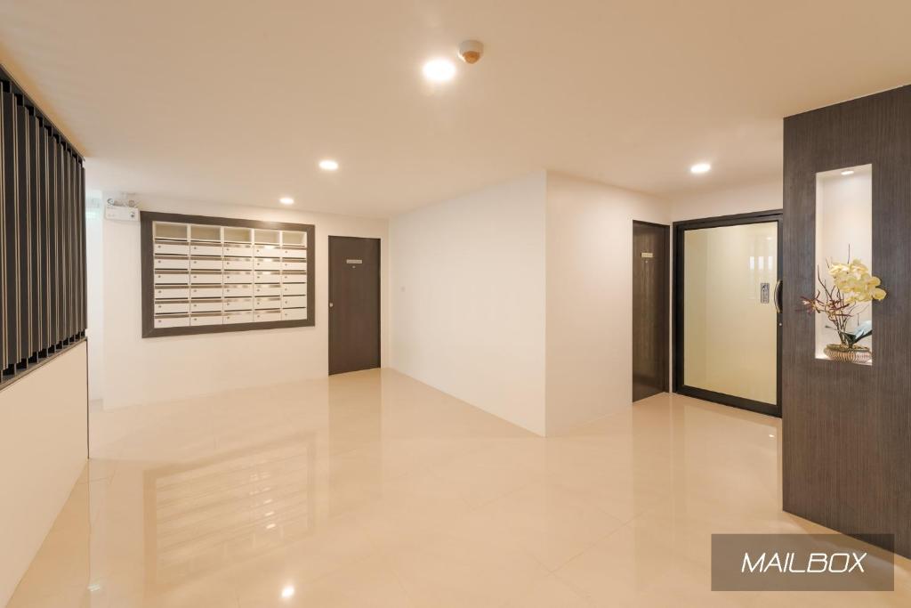 A polished residential hallway with mailboxes, lift access and multiple doors.