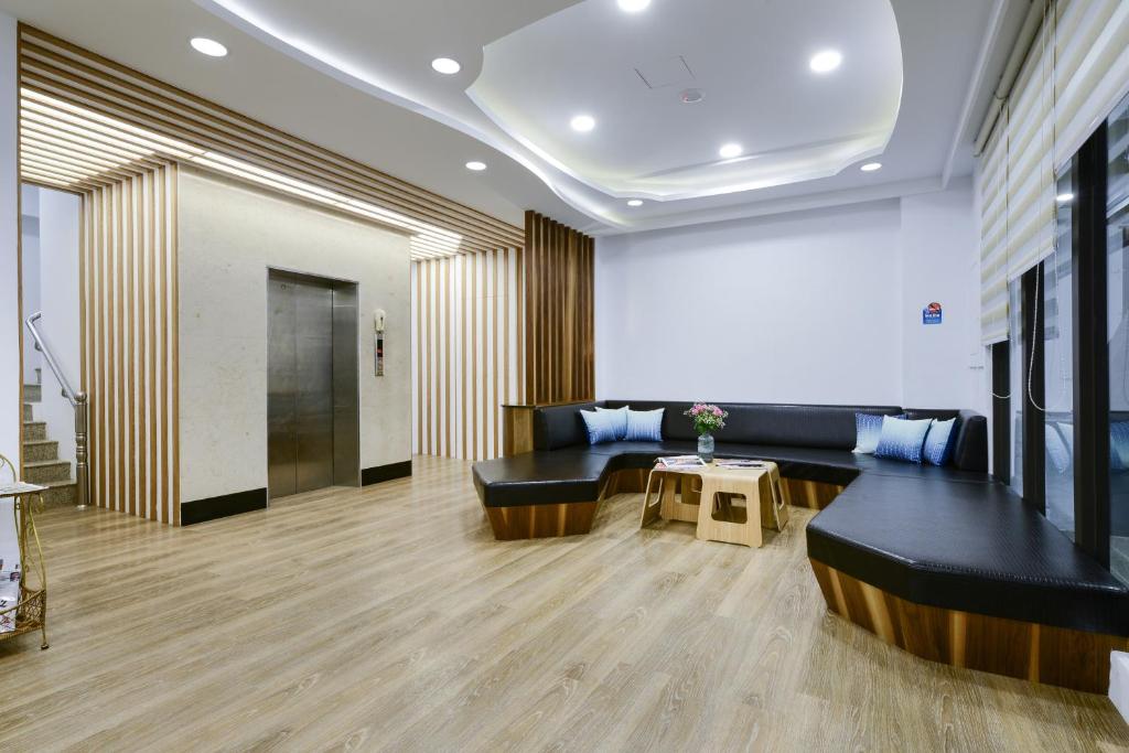 a lobby with a black couch and a table at Kenting Coast Resort in Kenting