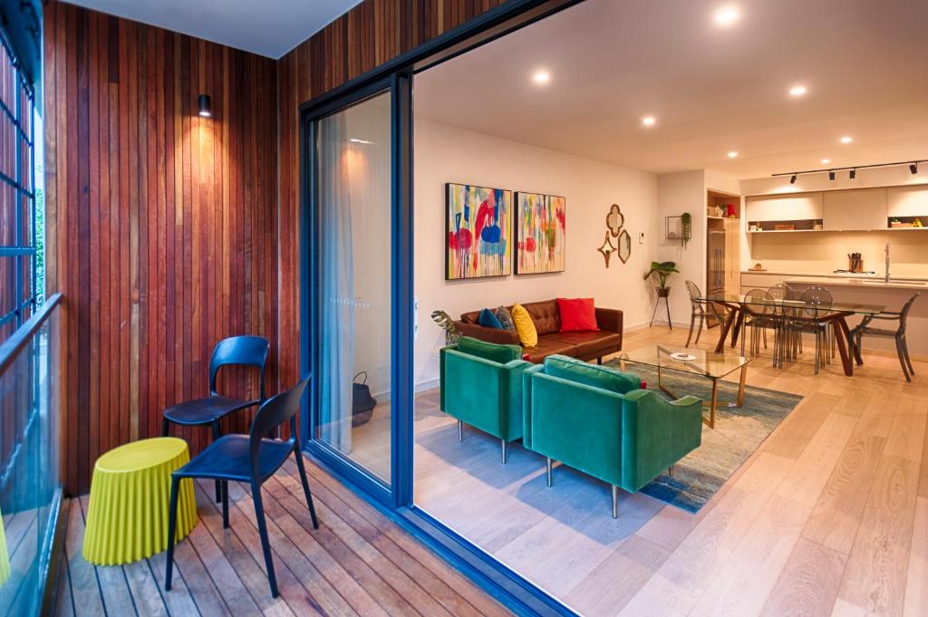 a living room with a couch and a table at Orange Stay Townhouses in Melbourne