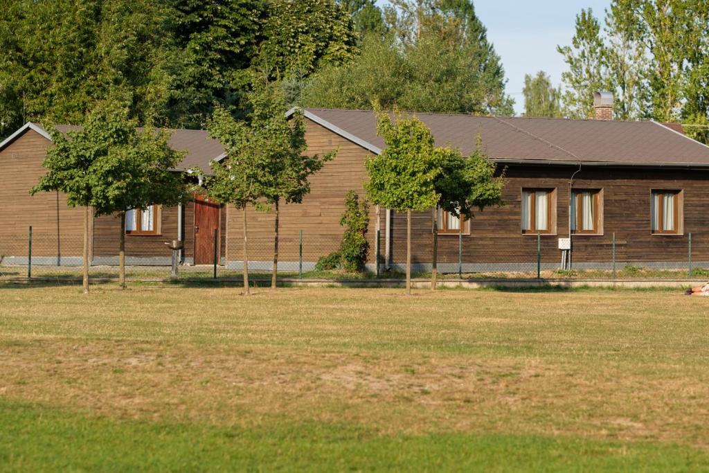 a large building with a fence in front of it at BeachCamp Nová Role in Nová Role