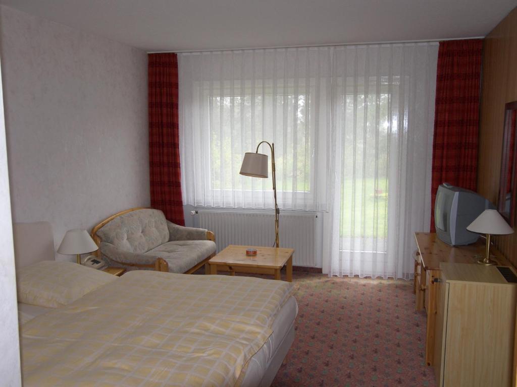 Postel nebo postele na pokoji v ubytování Wolfs Hotel