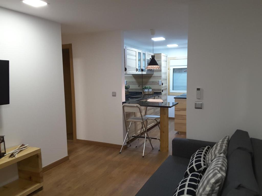 a living room and kitchen with a couch and a table at Best house airport lisbon in Lisbon