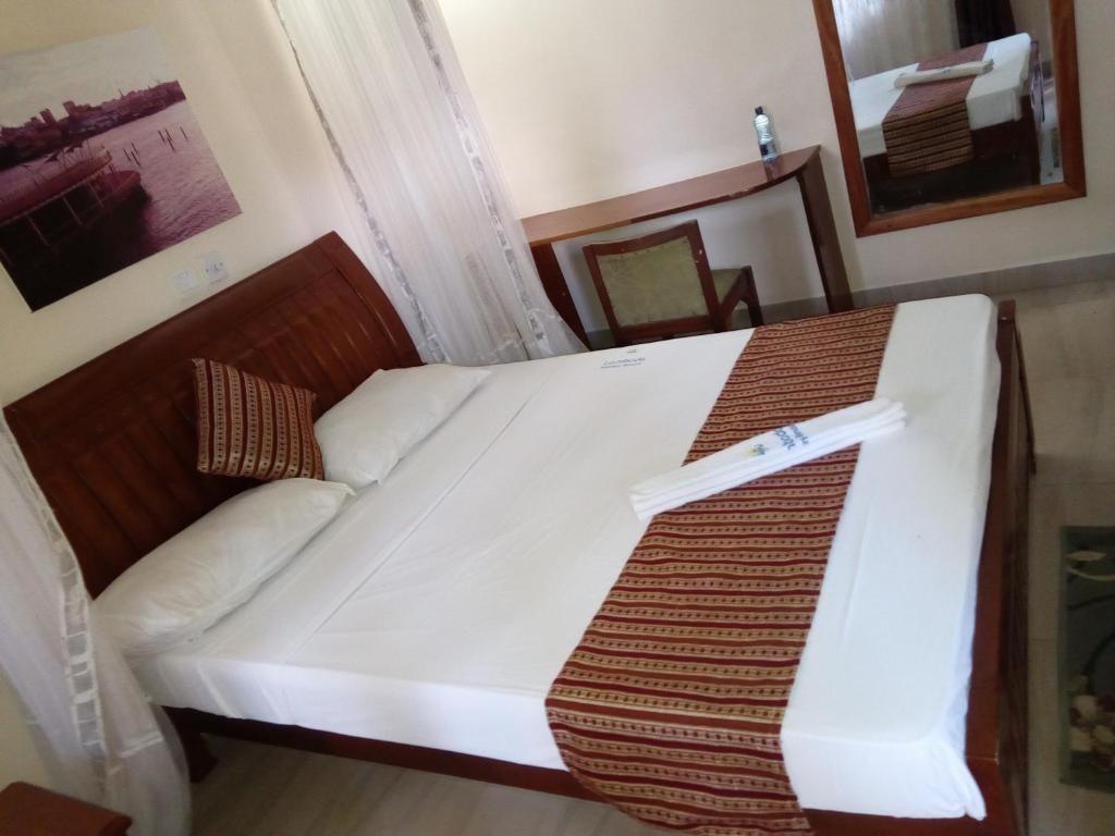 Postel nebo postele na pokoji v ubytování Lambada Holiday Resort Mombasa
