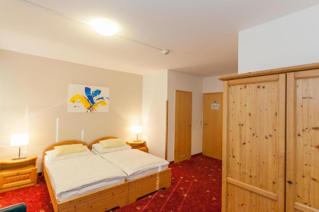 Postel nebo postele na pokoji v ubytování Hotel Vösenhuber