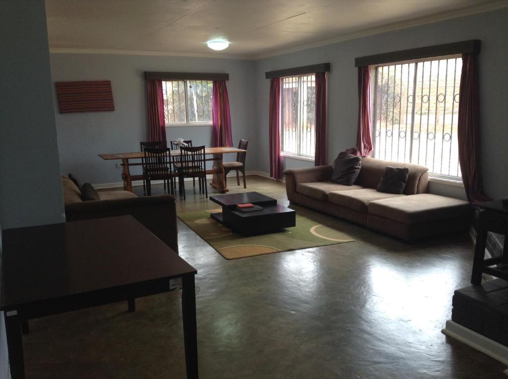 a living room with a couch and a table at Teule Guest House in Oloitokitok 