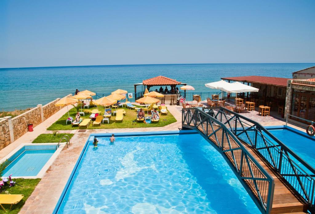 a swimming pool with the ocean in the background at Ekavi Hotel in Sfakaki