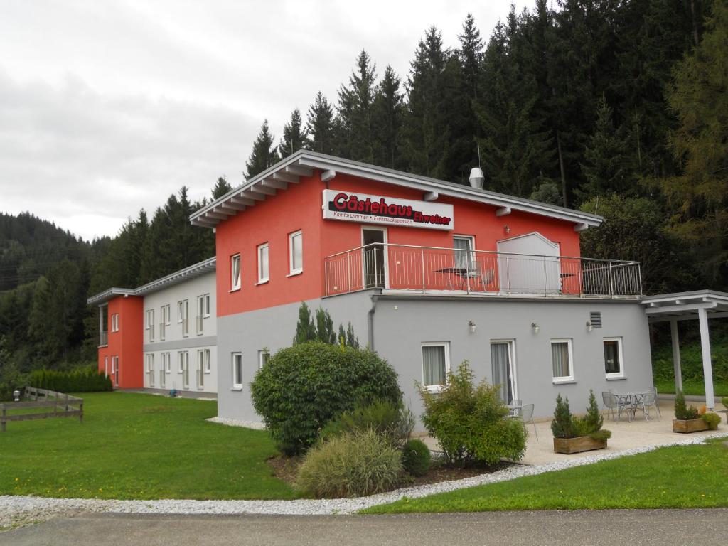 a building with a red and white building at Gästehaus Ehweiner in Pöls