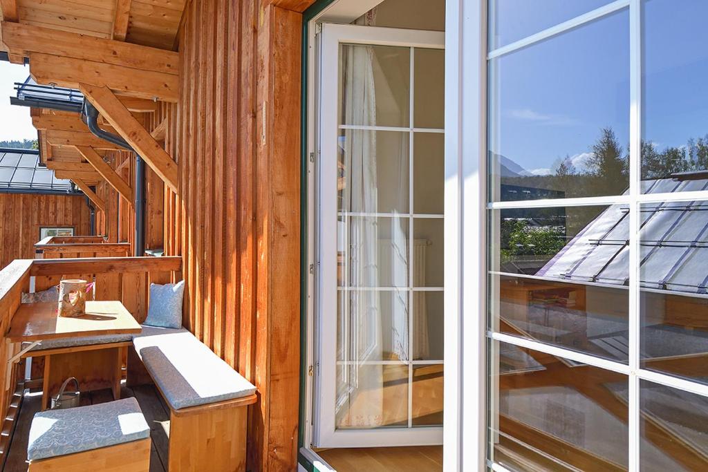 a balcony with a desk and a sliding glass door at Ferienwohnung Hentschel in Altaussee