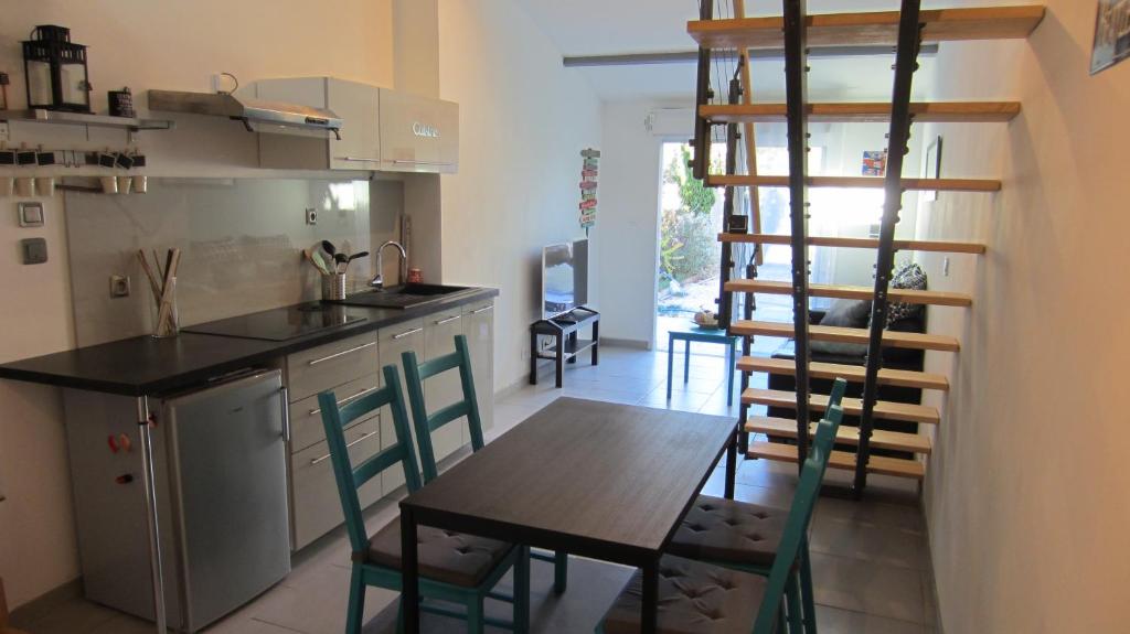 a kitchen with a table and chairs in a room at Studio A Grans in Grans