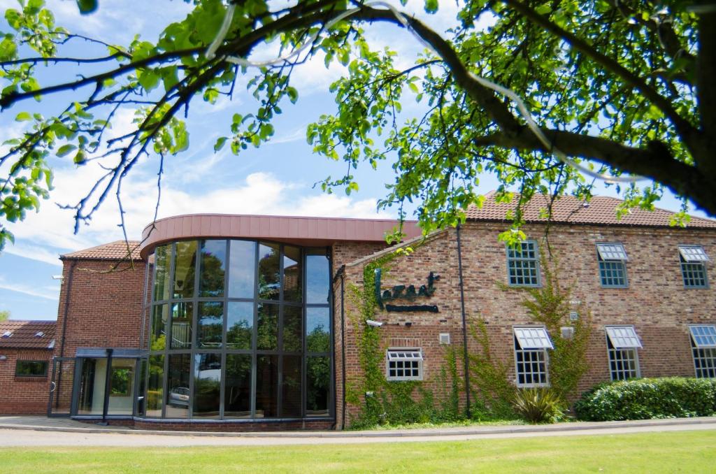 an external view of a brick building with a large window at Lazaat Hotel in Hull