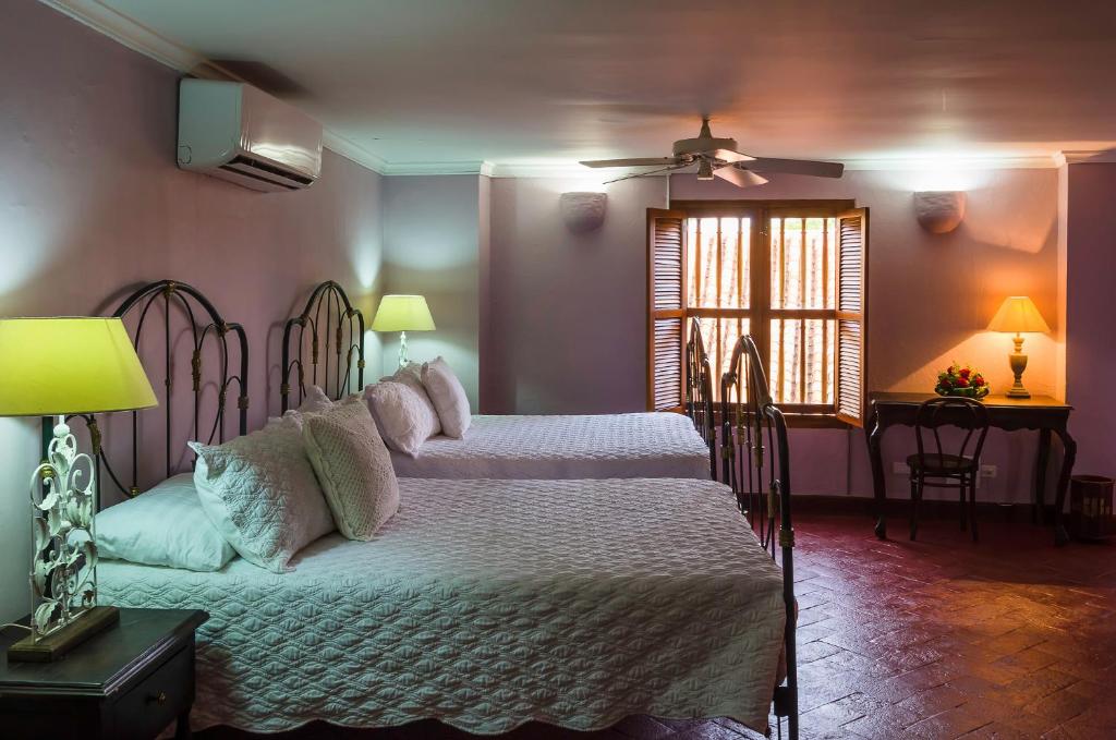 Postel nebo postele na pokoji v ubytování Hotel Boutique Casa Córdoba Estrella