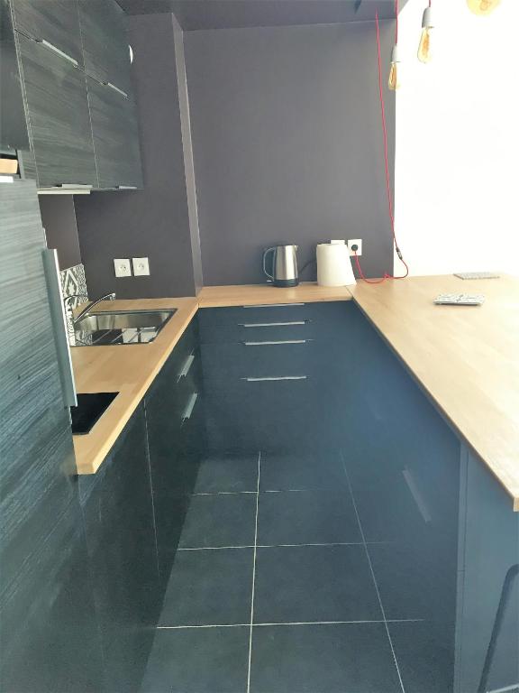 a kitchen with blue cabinets and a counter top at Quintessens in Marseille
