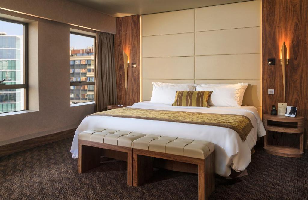 a hotel room with a large bed and a window at Hotel Regal Pacific Santiago in Santiago