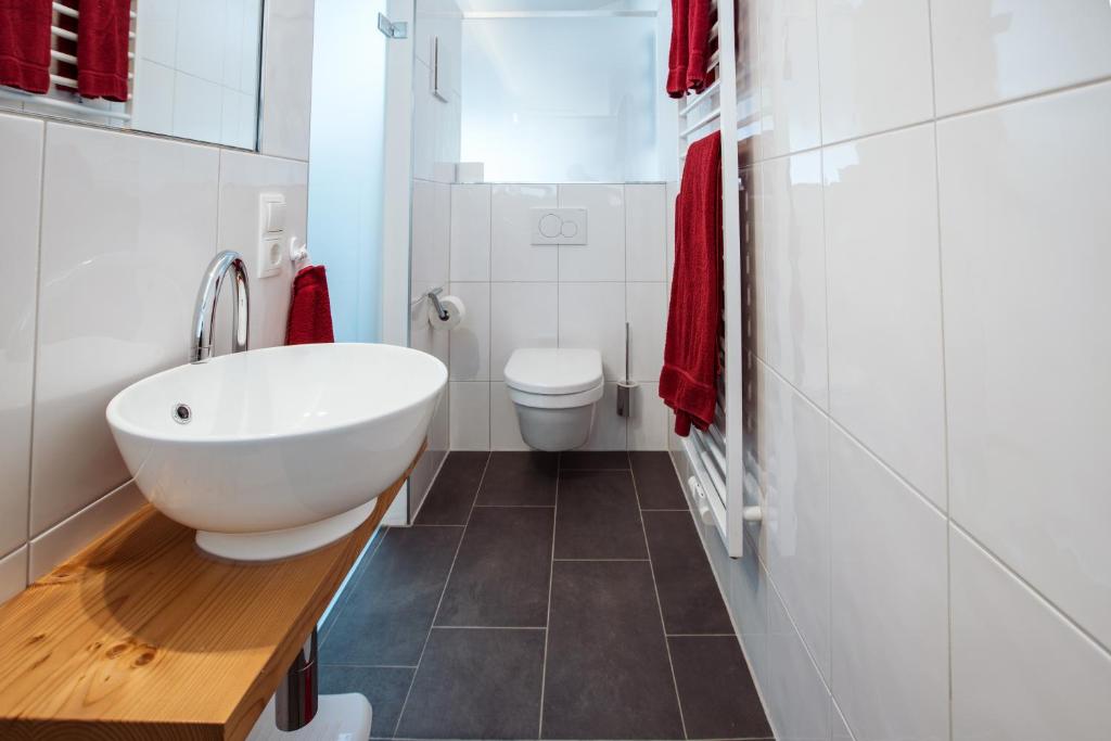 a bathroom with a white sink and a toilet at Panoramablick in Schruns-Tschagguns