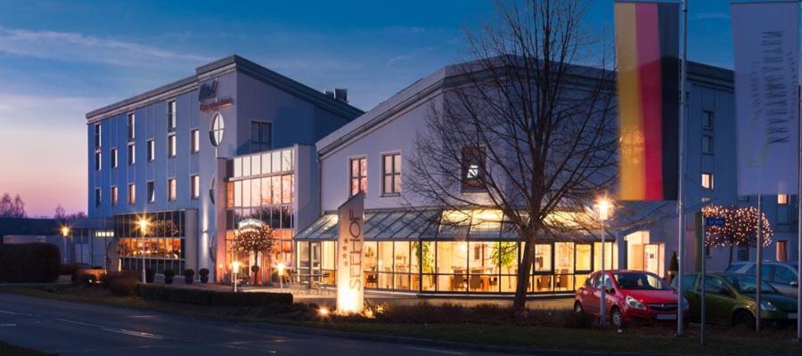 a building with a car parked in front of it at Hotel Seehof Leipzig in Zwenkau