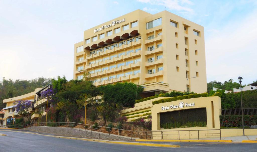 a large hotel building on the side of a street at Hotel Fortin Plaza in Oaxaca City