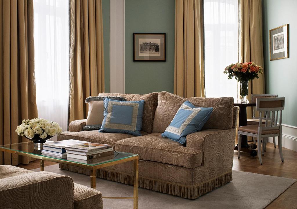 a living room with a couch and a table at Grand Hôtel Stockholm in Stockholm