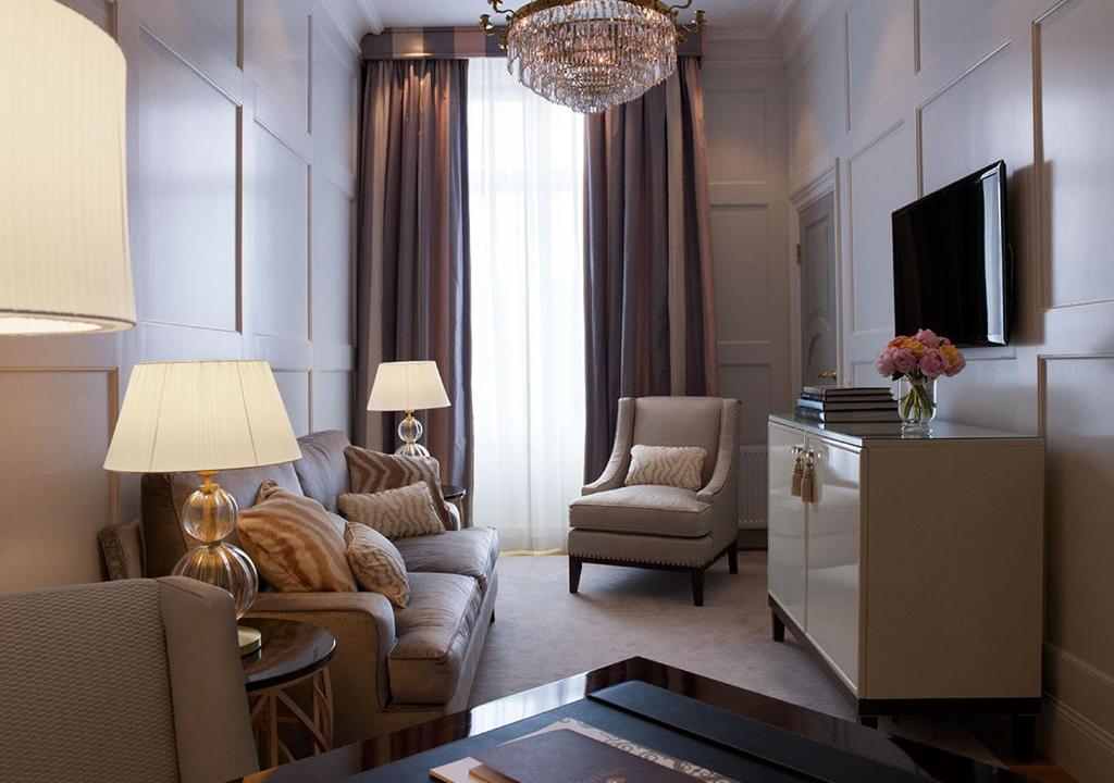 a living room with a couch and a tv at Grand Hôtel Stockholm in Stockholm