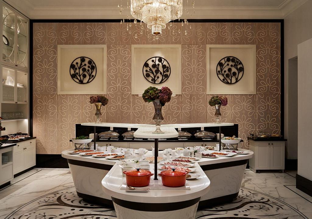 a restaurant with a buffet line with plates of food at Grand Hôtel Stockholm in Stockholm