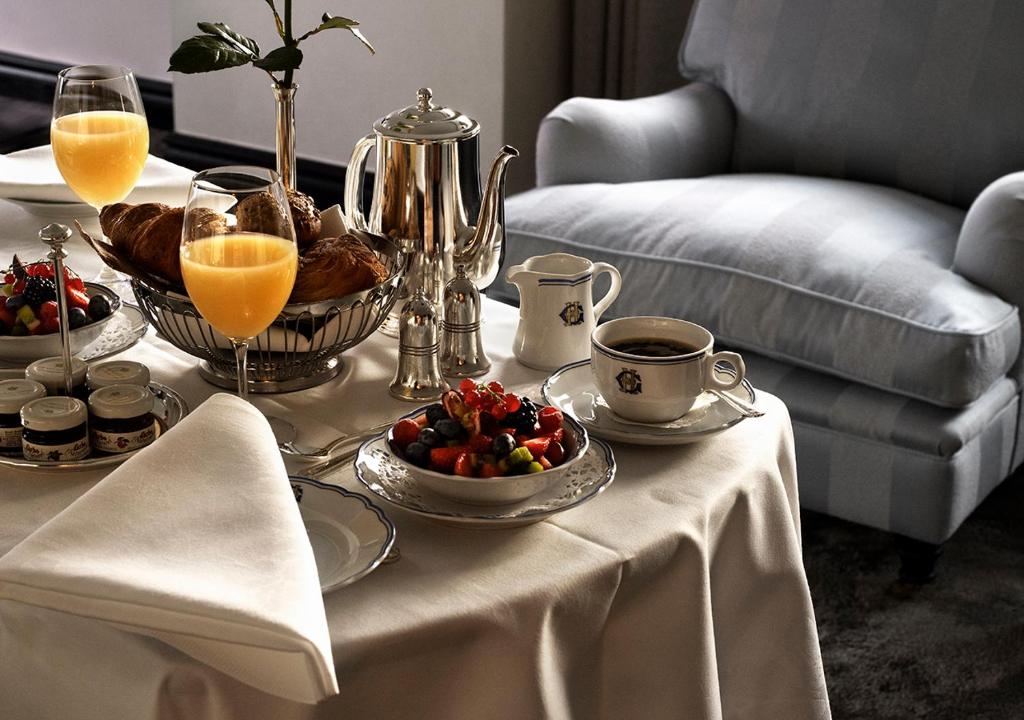a table with breakfast foods and drinks on it at Grand Hôtel Stockholm in Stockholm