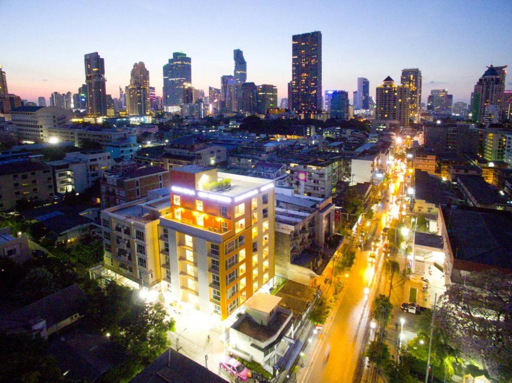 un perfil urbano por la noche con edificios iluminados en Parvena Hotel Sathorn, en Bangkok