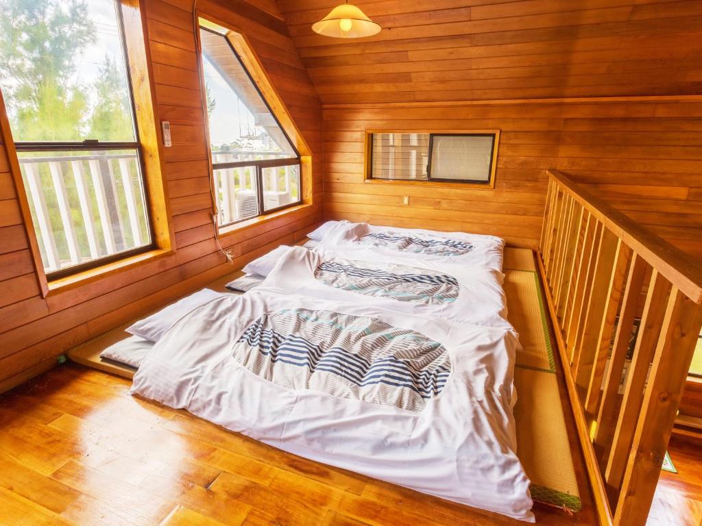 Postel nebo postele na pokoji v ubytování Kariyushi Condominium Resort Yuudekiya