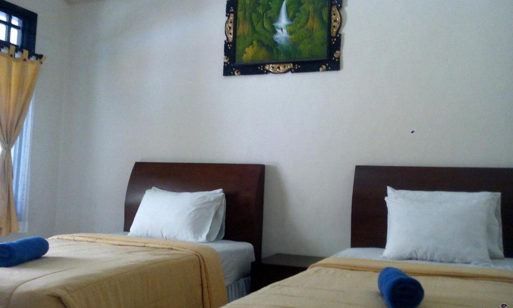 Postel nebo postele na pokoji v ubytování Bali Diva Hotel Kuta