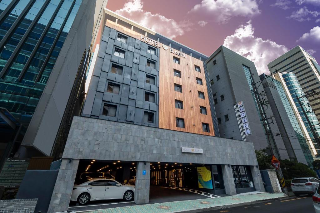 a white car parked in front of a building at Bcent hotel in Busan