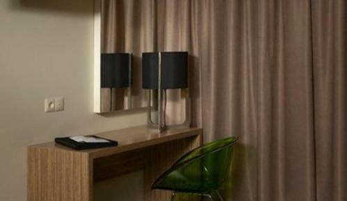 a room with a mirror and a table with a plant at Hotel Moon in A Coruña