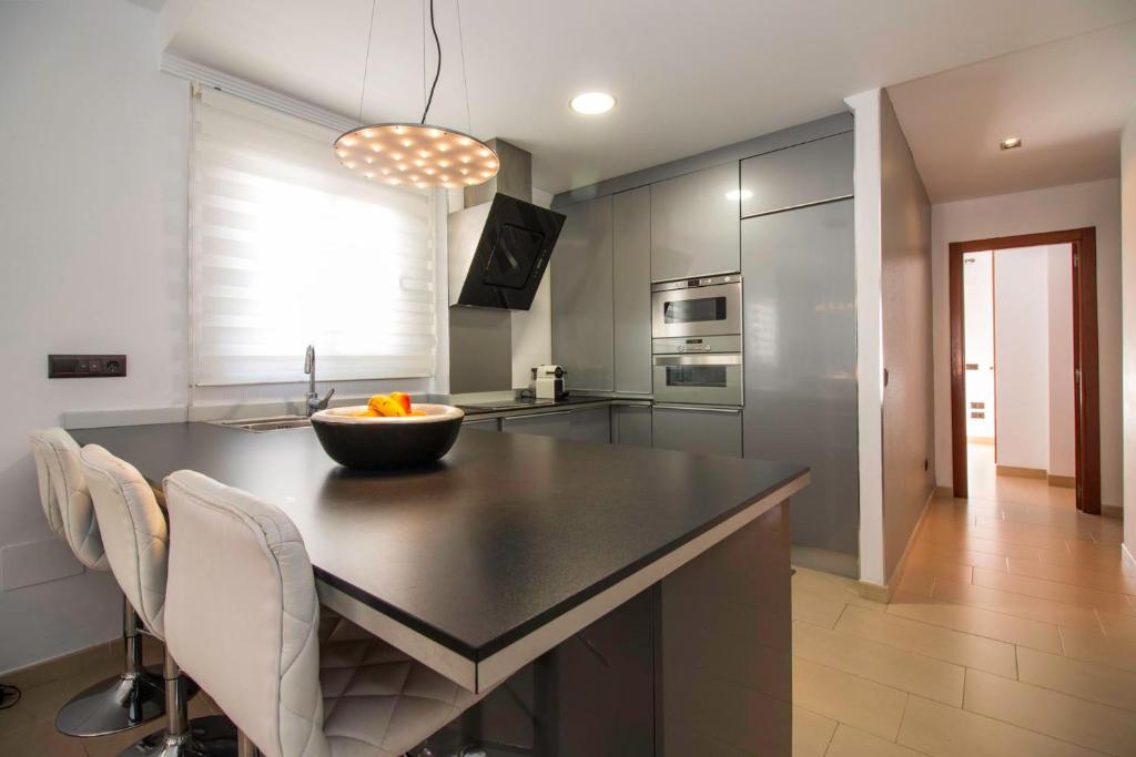 a kitchen with a island with a bowl on it at Plaza de España Boutique Apartment in Nerja