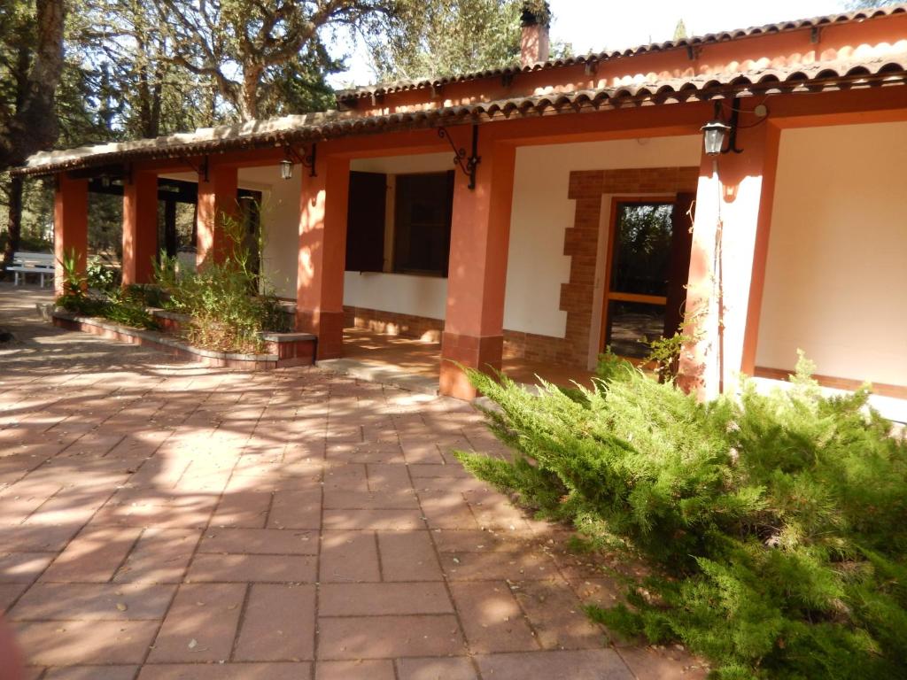 an orange and white building with a patio at Villa Teresa in Olmedo