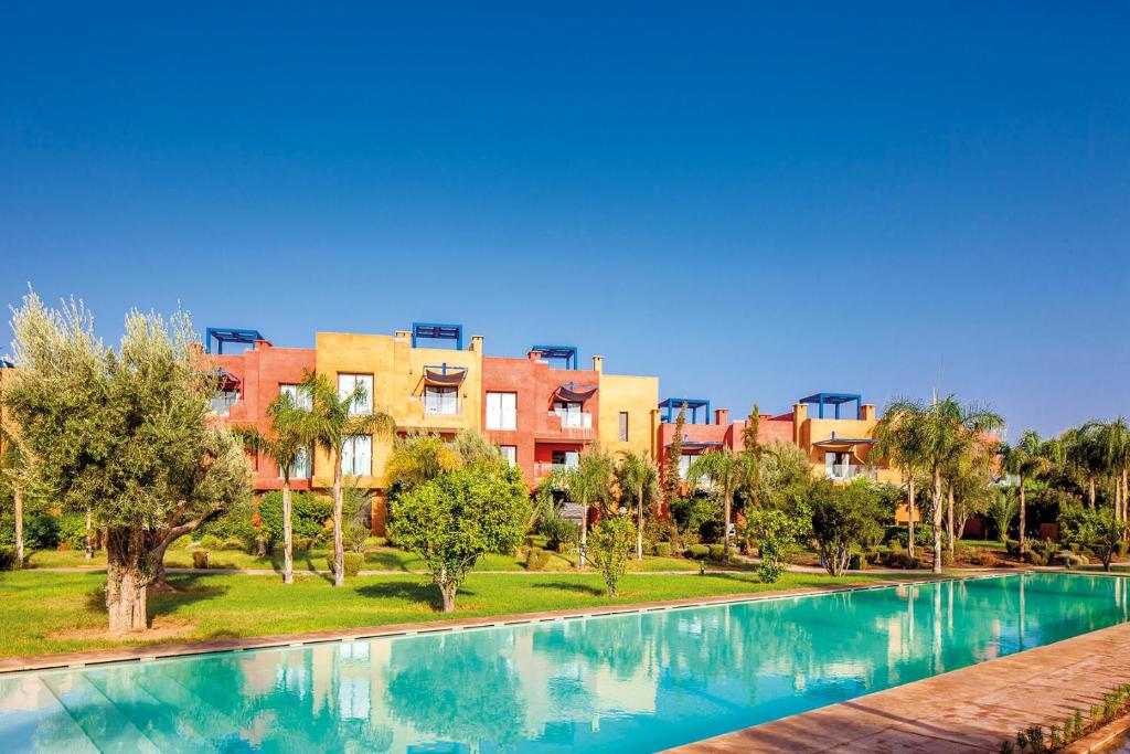 a swimming pool in front of some apartment buildings at Appartement Priv&eacute; au Vizir Center Marrakech in Marrakech