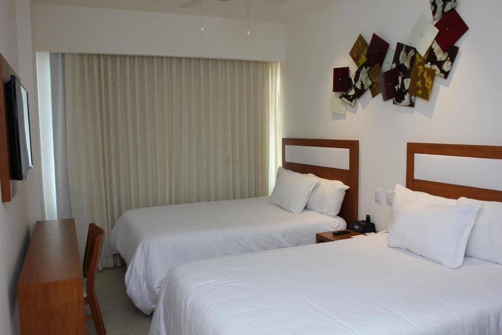 Postel nebo postele na pokoji v ubytování Ambiance Suites