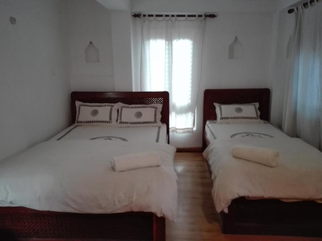Postel nebo postele na pokoji v ubytování Sunny Guest House and Cafe