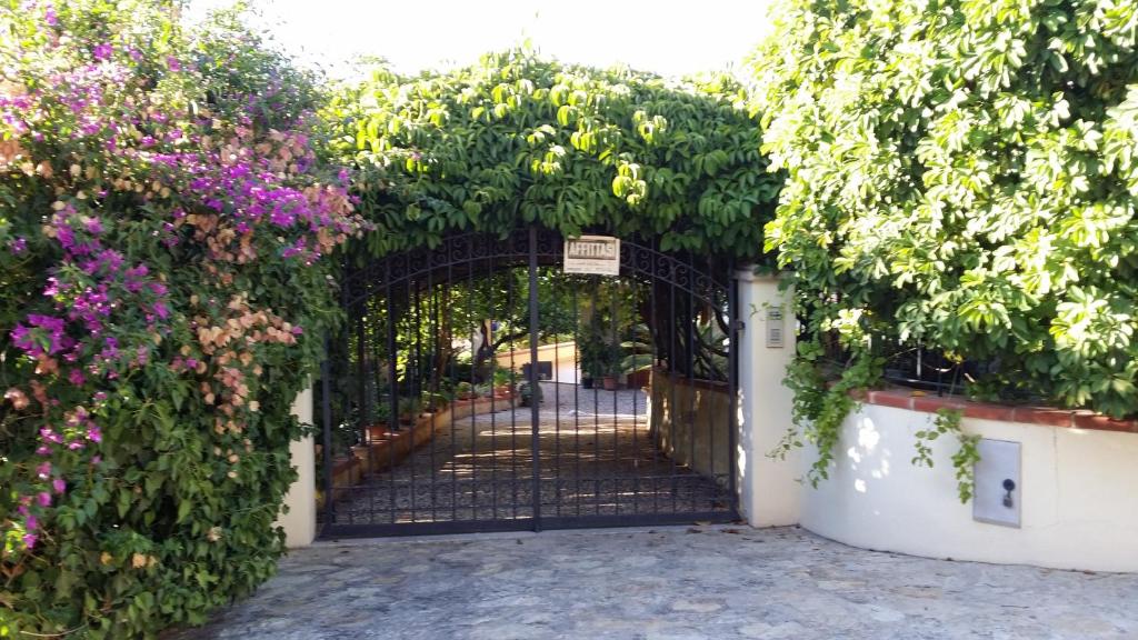 an entrance gate to a garden with flowers at Casa Rosalba in San Vito lo Capo
