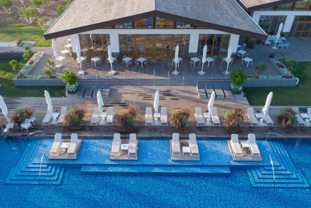 an overhead view of a pool with chairs and a resort at The Setai Sea Of Galilee in Ein Gev