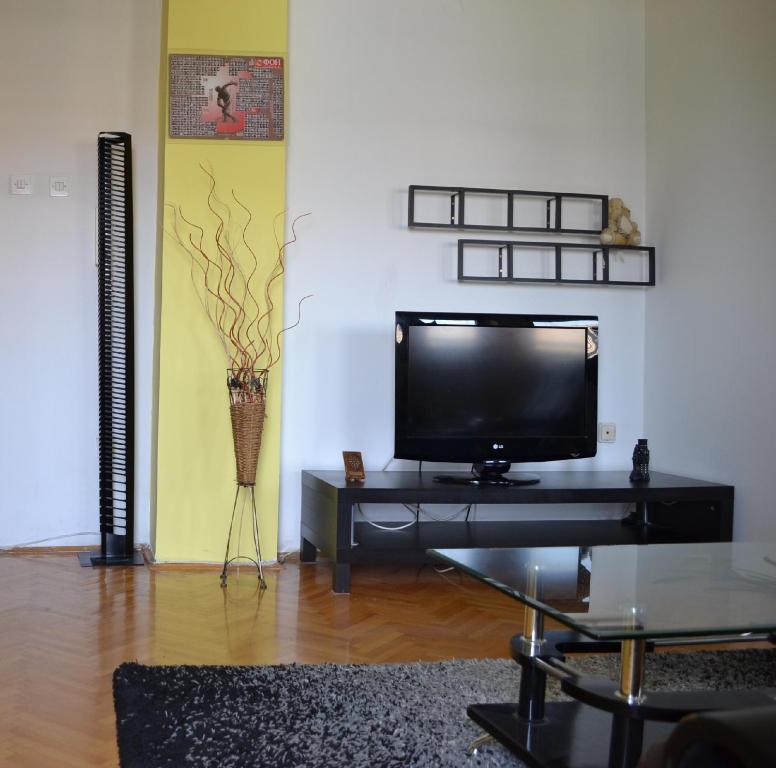 a living room with a flat screen tv on a table at Nakov Apartment next to bus station in Skopje