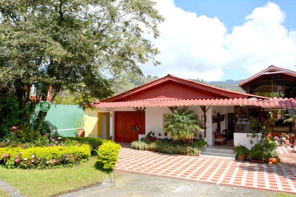 a house with a red roof at Cabañas Las Bifloras in Santa Rosa de Cabal