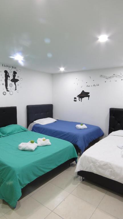 Postel nebo postele na pokoji v ubytování Hotel Bogota House