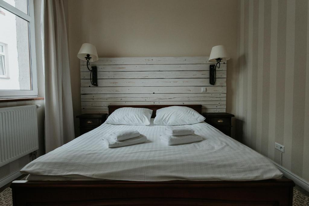 Postel nebo postele na pokoji v ubytování Apartamenty Kuźnia