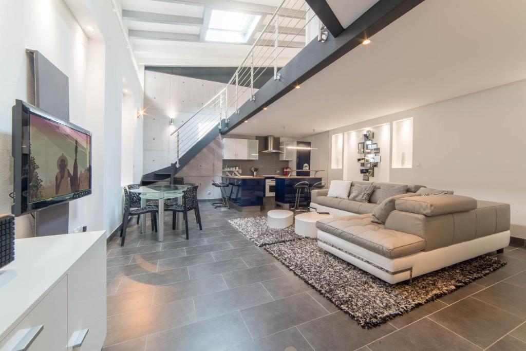 a living room with a couch and a table at LE LOFT 67 in Strasbourg