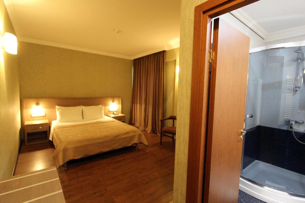 Postel nebo postele na pokoji v ubytování Batesta Hotel
